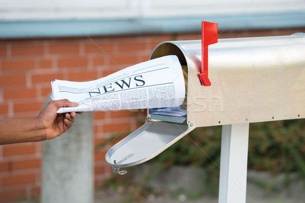 Person's Hand Opening Mailbox To Remove Newspaper Stock photo © AndreyPopov