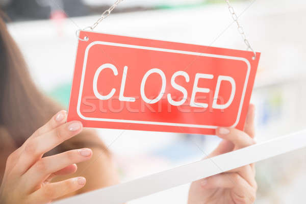 Owner Holding Closed Sign In Clothing Store Stock photo © AndreyPopov