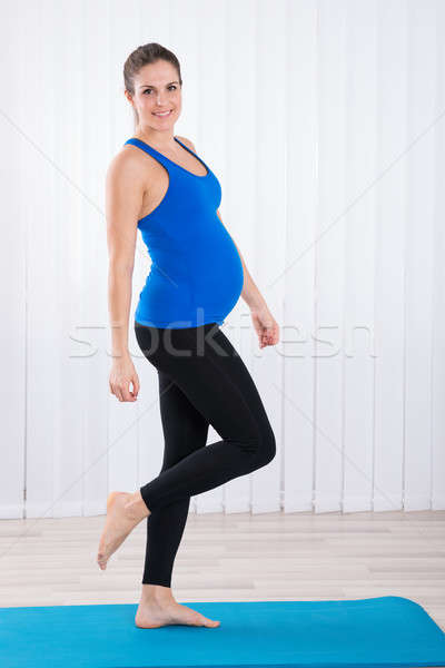 Portrait Of Pregnant Woman Standing On Exercise Mat Stock photo © AndreyPopov