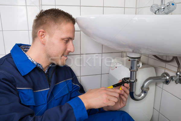 Plumber Repairing Sink In Bathroom Stock photo © AndreyPopov