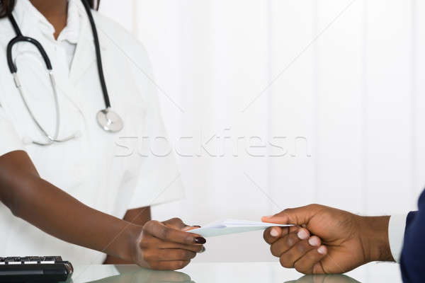 Doctor Giving A Prescription To His Patient Stock photo © AndreyPopov