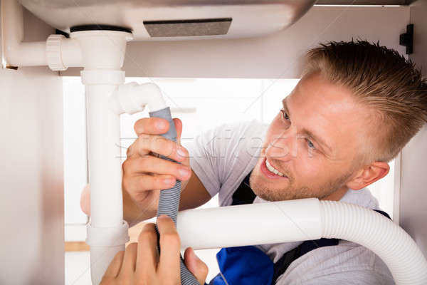 Close-up Of Plumber Repairing Sink Pipe Stock photo © AndreyPopov