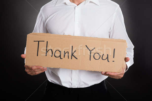 Close-up Of Man Holding Cardboard With Thank You Text Stock photo © AndreyPopov