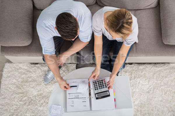 Overhead View Of A Couple Calculating Bills Stock photo © AndreyPopov