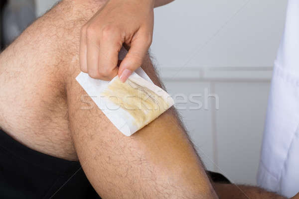Beautician Waxing Man's Leg Stock photo © AndreyPopov
