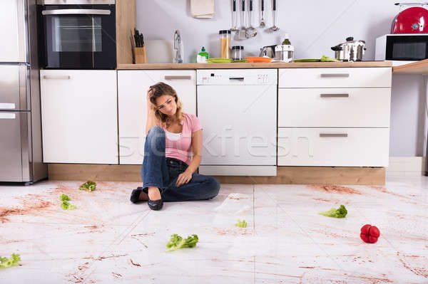 Woman Sitting On Messy Kitchen Floor Stock photo © AndreyPopov