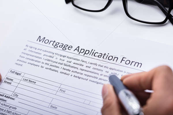 Human Hand Filling Mortgage Application Form Stock photo © AndreyPopov