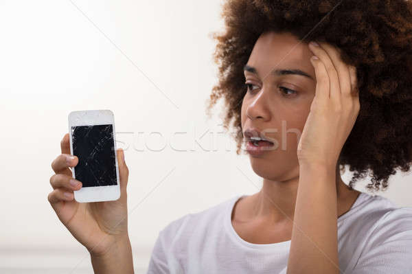 Woman Holding Broken Mobile Phone Stock photo © AndreyPopov