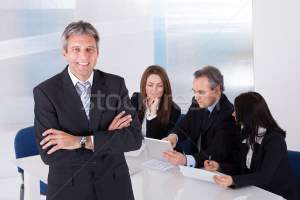 Businessman Standing In Front Of Colleagues Stock photo © AndreyPopov