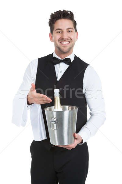 Waiter Holding Ice Bucket With Champagne Bottle Stock photo © AndreyPopov