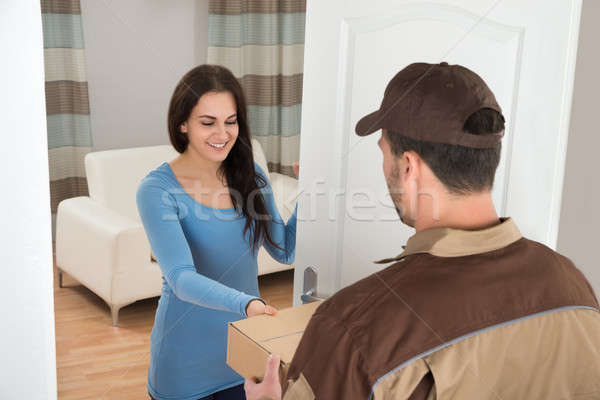 Young Woman Receiving Courier From Delivery Man Stock photo © AndreyPopov