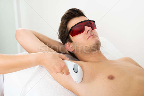 Person Hands Giving Laser Epilation Therapy To Man Stock photo © AndreyPopov