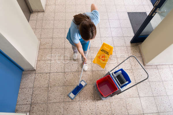 Janitor Mopping Floor With Cleaning Equipments Stock photo © AndreyPopov