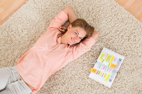 Woman With Diary Lying On Carpet Stock photo © AndreyPopov