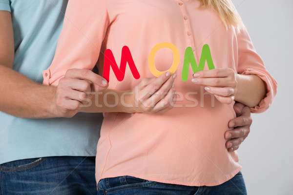 Expecting Couple Holding Word Mom Stock photo © AndreyPopov
