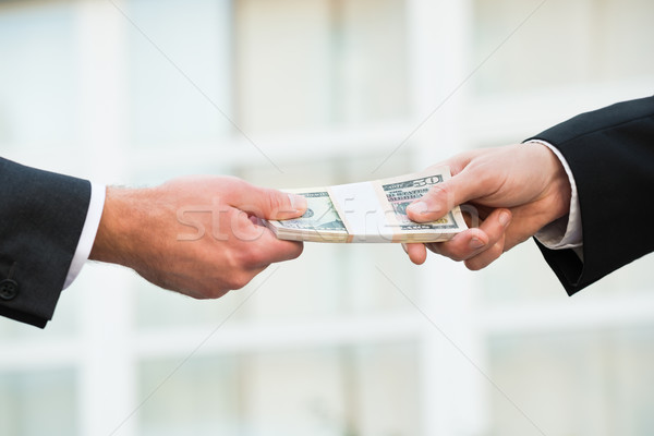 Businessman Giving Bribe To Partner Stock photo © AndreyPopov