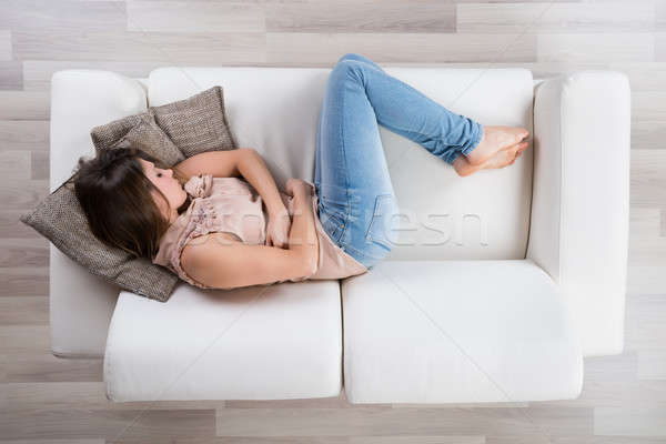 Young Woman Napping On Sofa Stock photo © AndreyPopov