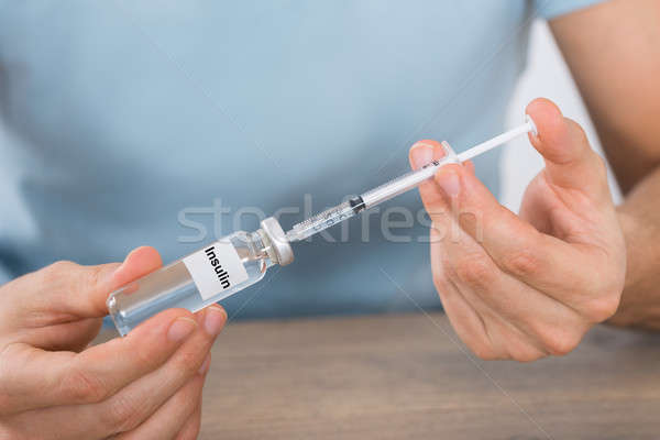 Férfi tart inzulin injekciós tű közelkép fiatalember Stock fotó © AndreyPopov