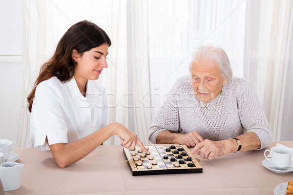 Two Women Playing Checkers Game Stock photo © AndreyPopov