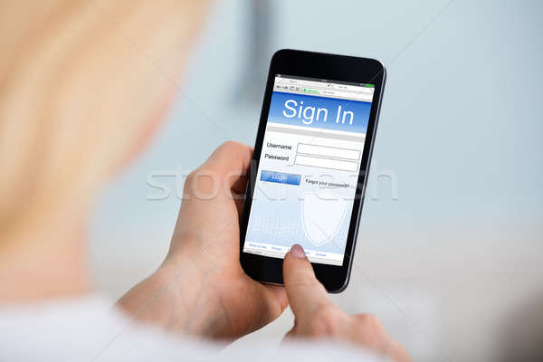 Woman Signing Into Website On Mobilephone Stock photo © AndreyPopov