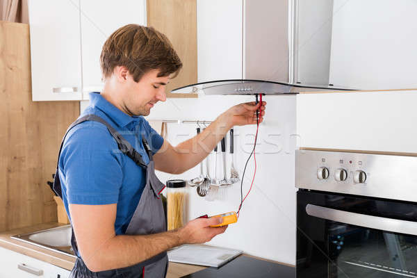Repairman Checking Kitchen Extractor Filter Stock photo © AndreyPopov