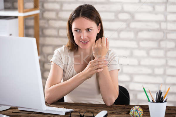 Businesswoman Holding Her Wrist Stock photo © AndreyPopov