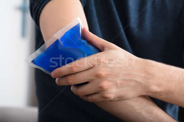 Person Applying Ice Gel Pack On An Injured Elbow Stock photo © AndreyPopov