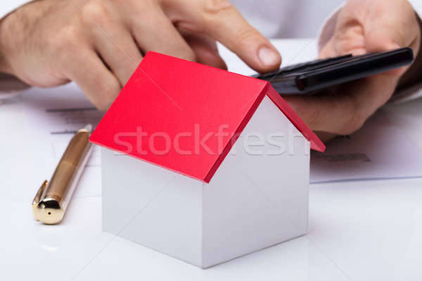 Ház modell személyek kéz számológép közelkép Stock fotó © AndreyPopov