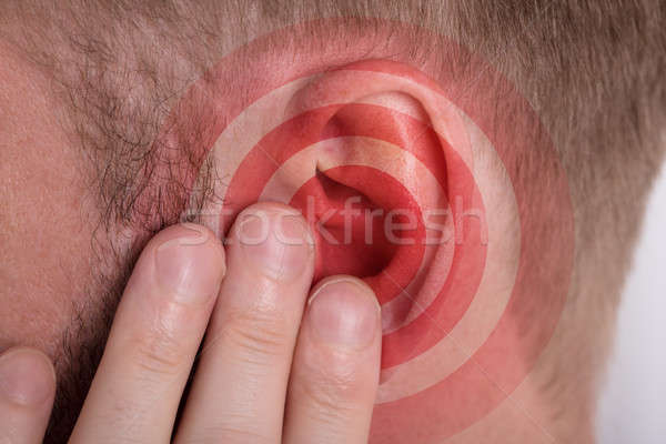 Red Circle On Man's Ear Stock photo © AndreyPopov