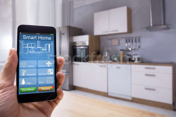 Person Using Smart Home System On Mobilephone Stock photo © AndreyPopov