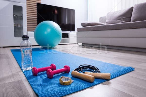 Stock photo: Skipping Rope And Pink Dumbbells On Exercise Mat