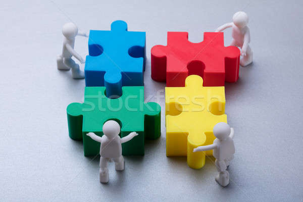 Human Figures Solving Jigsaw Puzzle Stock photo © AndreyPopov