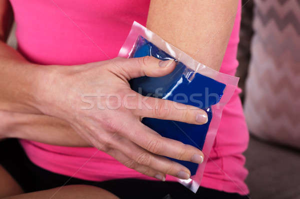 Woman Applying Ice Bag On Her Elbow Stock photo © AndreyPopov