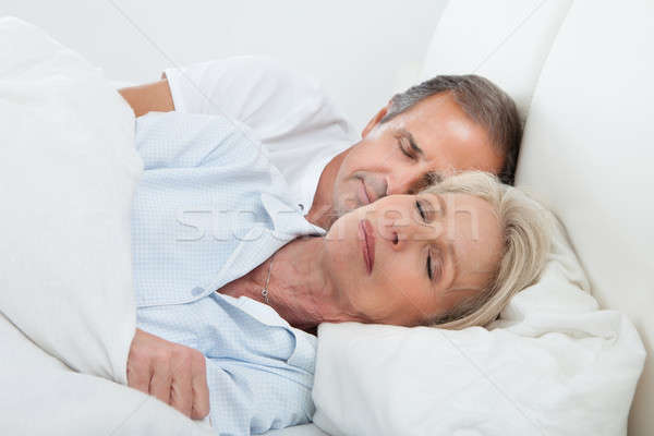 Happy Senior Couple On Sleeping Bed Stock photo © AndreyPopov