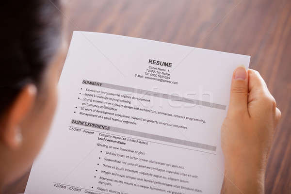 Young Businesswoman Reading Resume Stock photo © AndreyPopov