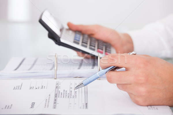 Businessman Using Calculator In Office Stock photo © AndreyPopov
