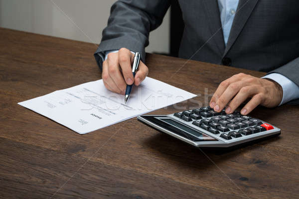 üzletember számla közelkép számológép asztal papír Stock fotó © AndreyPopov