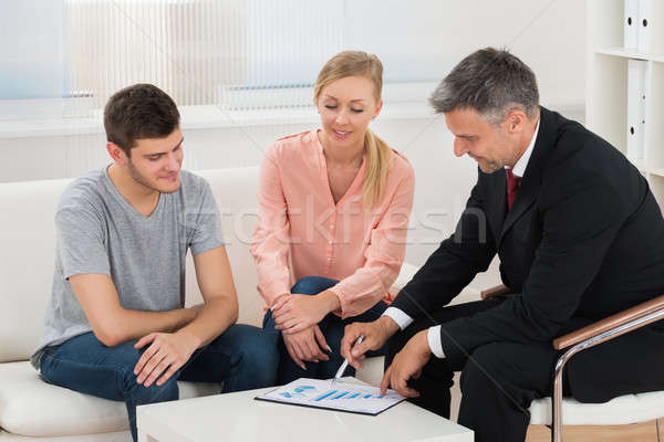Financial Advisor Showing Graph To Couple Stock photo © AndreyPopov