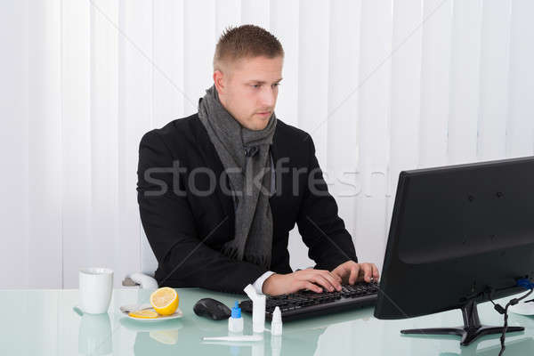 Sick Businessman Using Computer In Office Stock photo © AndreyPopov
