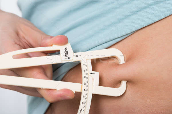 Man Measuring Stomach Fat Stock photo © AndreyPopov