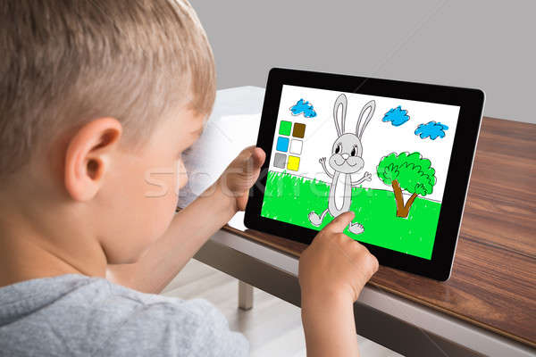 Boy Touching Screen On Digital Tablet Stock photo © AndreyPopov