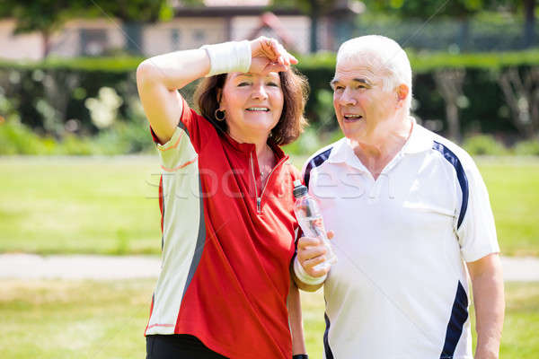 Tired Couple Holding Bottle In Park Stock photo © AndreyPopov
