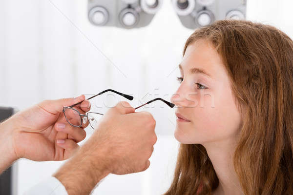 An Optician Helping Girl With New Eyeglasses Stock photo © AndreyPopov