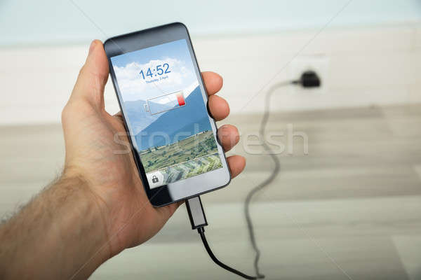 Person Charging His Mobilephone Stock photo © AndreyPopov