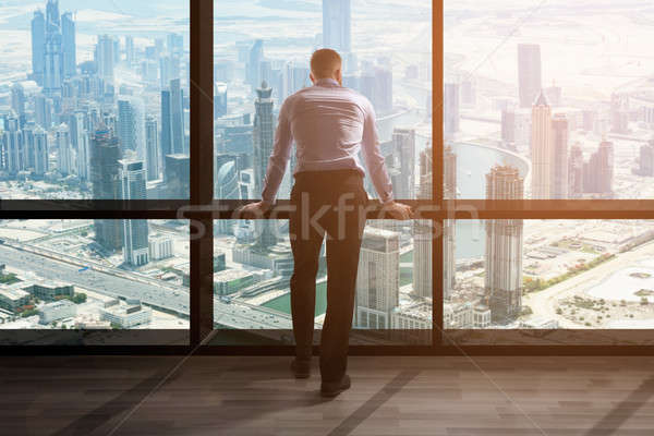 Businessman Looking At Cityscape Through Window Stock photo © AndreyPopov