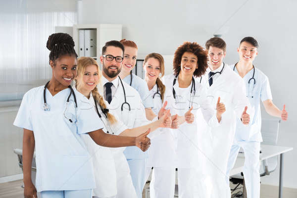 Multi Ethnic Male And Female Doctors Showing Thumb Up Sign Stock photo © AndreyPopov