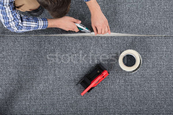 Carpenter Laying Carpet Stock photo © AndreyPopov