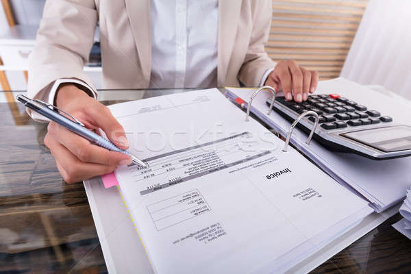 Mujer de negocios mano factura calculadora primer plano escritorio Foto stock © AndreyPopov