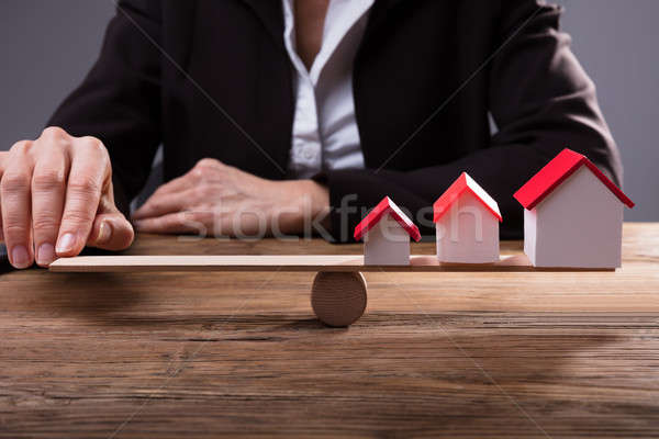 Human Finger Balancing House Models On Seesaw Stock photo © AndreyPopov