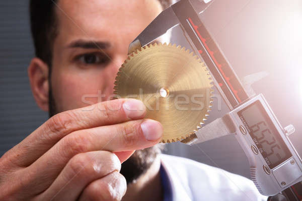 Man Measuring Gear's Size With Digital Caliper Stock photo © AndreyPopov